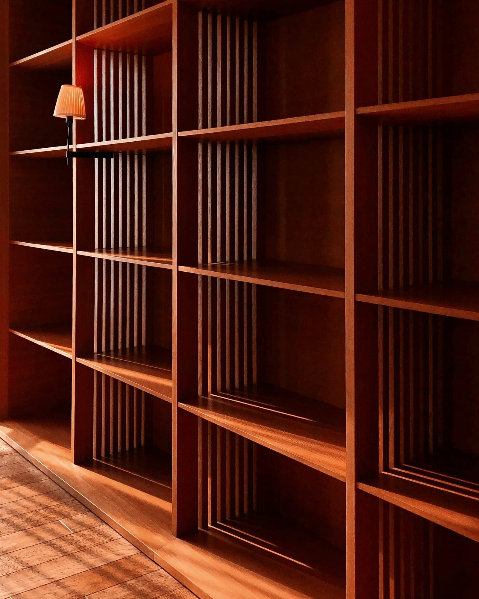 Custom slatted wood built-in shelving with warm ambient lighting